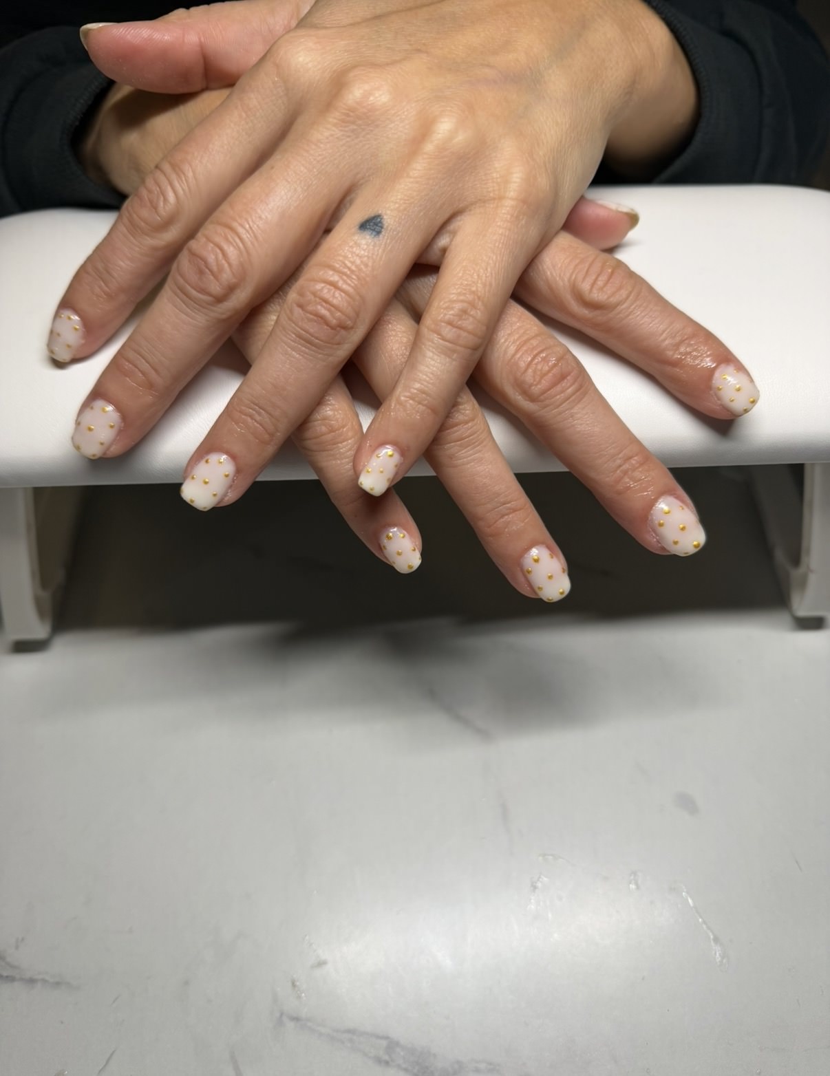 Velvet merlot inspired gel nails with pearl white and gold dotted accents by Raegan